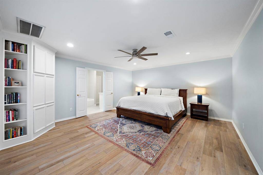 Step into the expansive primary bedroom, where comfort meets versatility.
