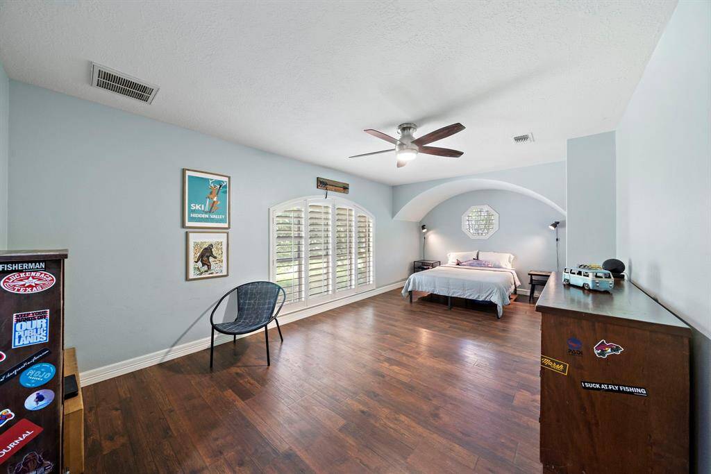 The secondary bedroom offers generous space and a built-in desk.
