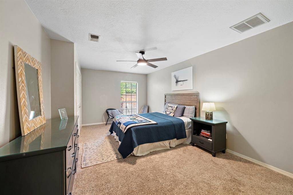 The third secondary bedroom featuring its dedicated bathroom with a standing shower.