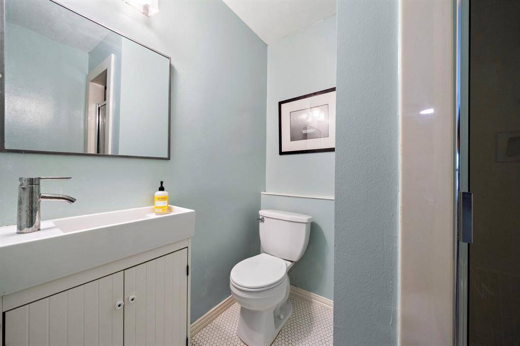 Secondary bathroom with standing shower.