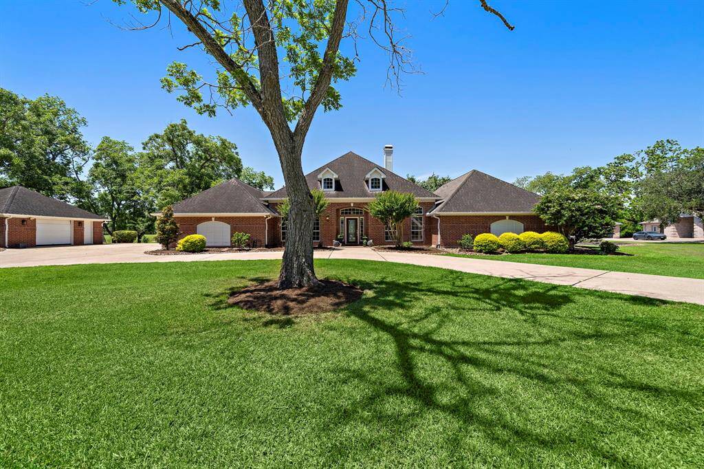 As you arrive, the circle driveway and grand four-car garage provide a stately welcome.