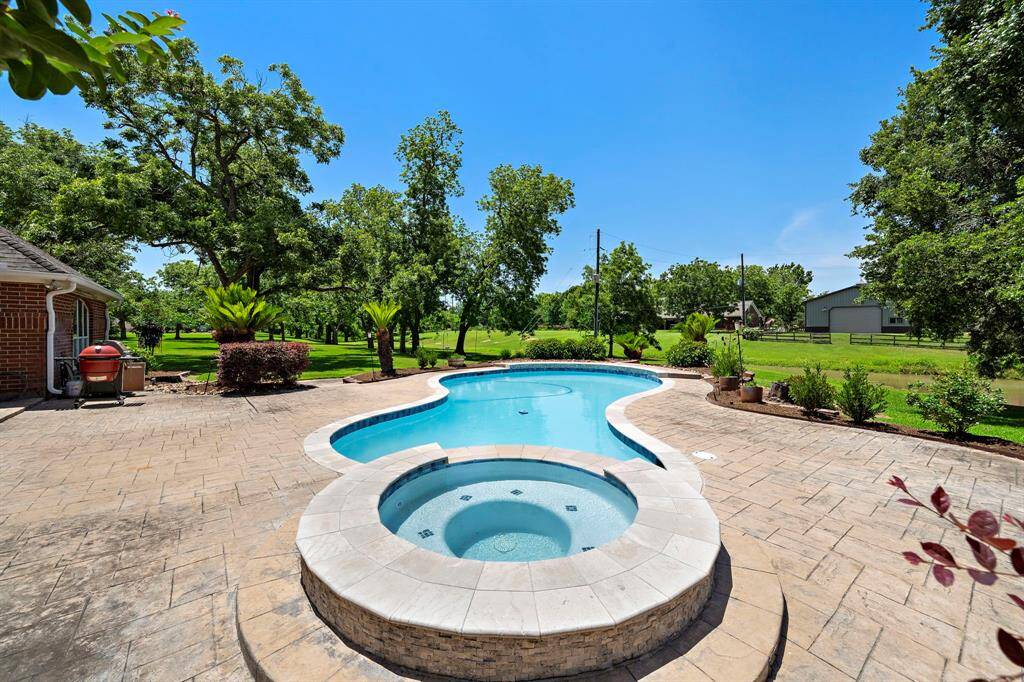 Majestic pecan trees line the lush yard, providing shade and a picturesque backdrop