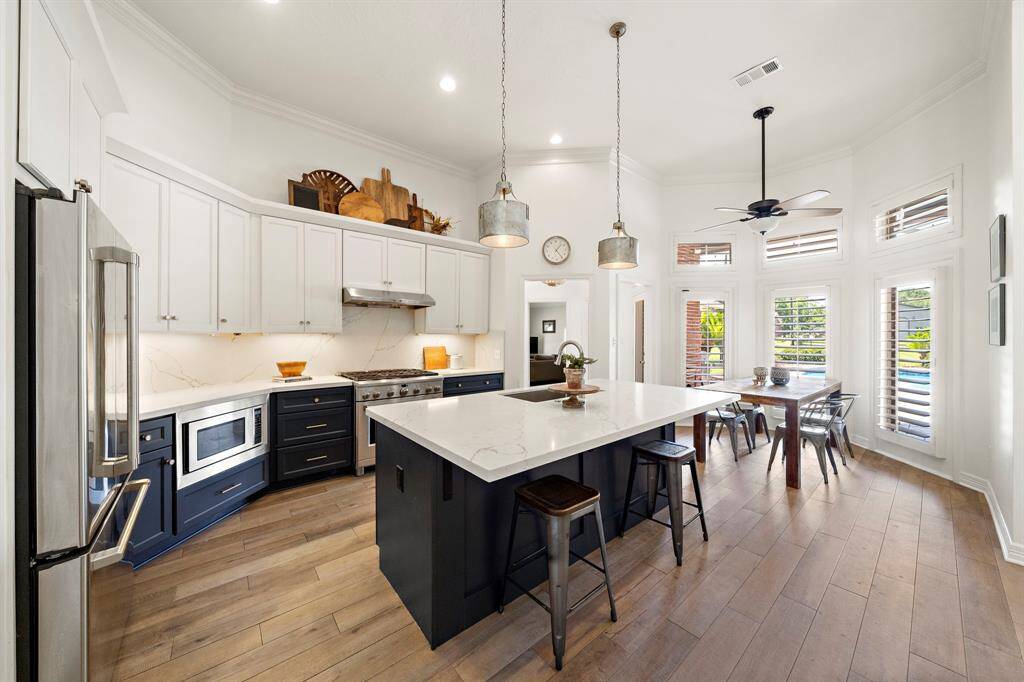 The heart of the home is a chef’s dream kitchen, offering updates with premium finishes, seamlessly flowing into the expansive living and dining areas—perfect for both entertaining and everyday living.