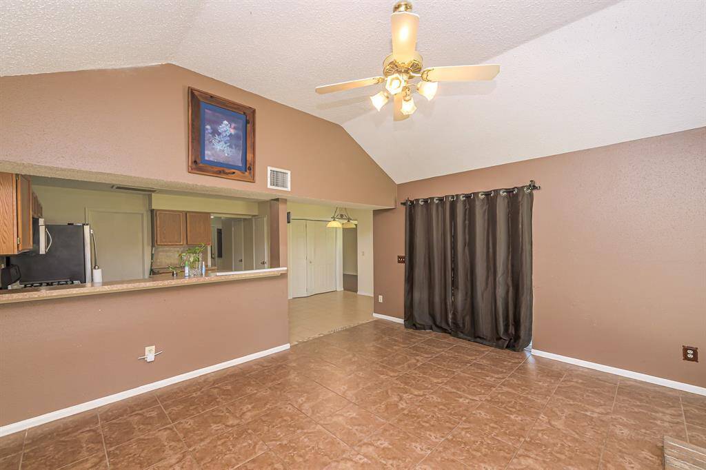 Open to kitchen area with long breakfast bar for additional seating