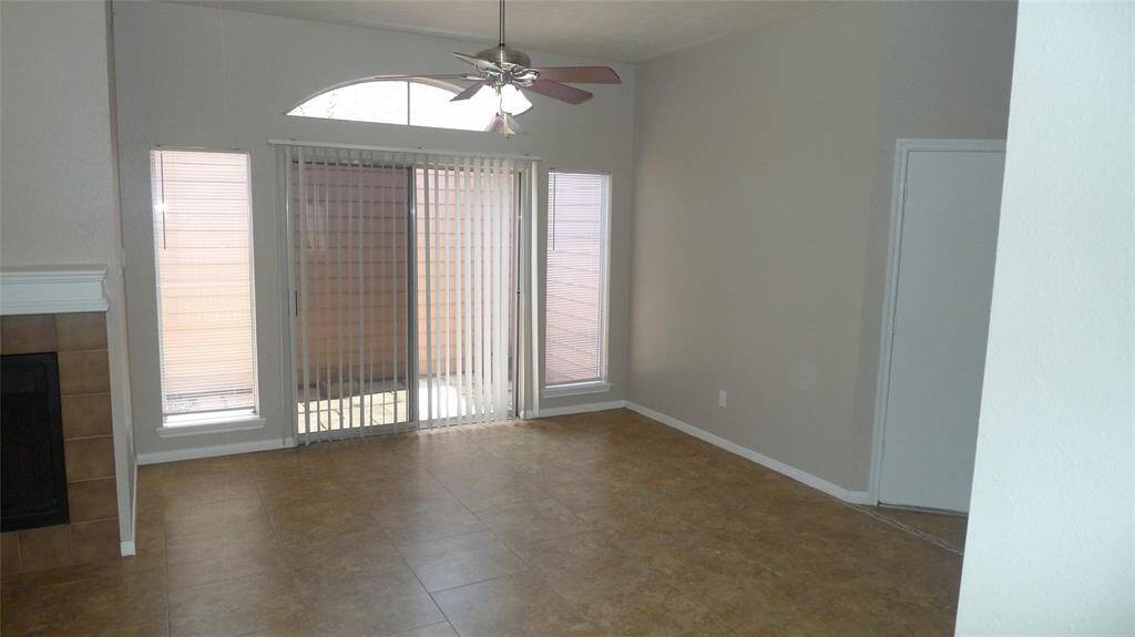 Comfortable living area with Ceiling fan opens up to a side patio and the side yard,,, leads to Backyard