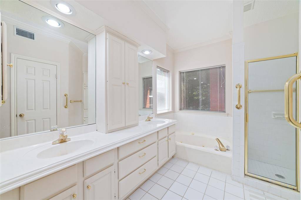 Primary bathroom with dual basins, soaking tub and separate shower