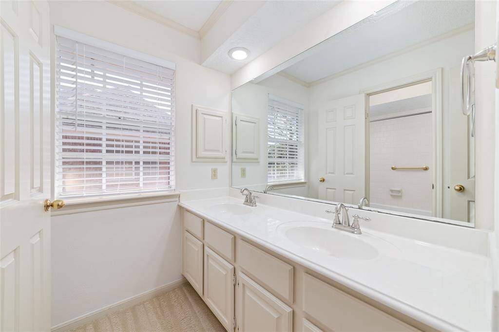 Seconary bathroom with dual basins.