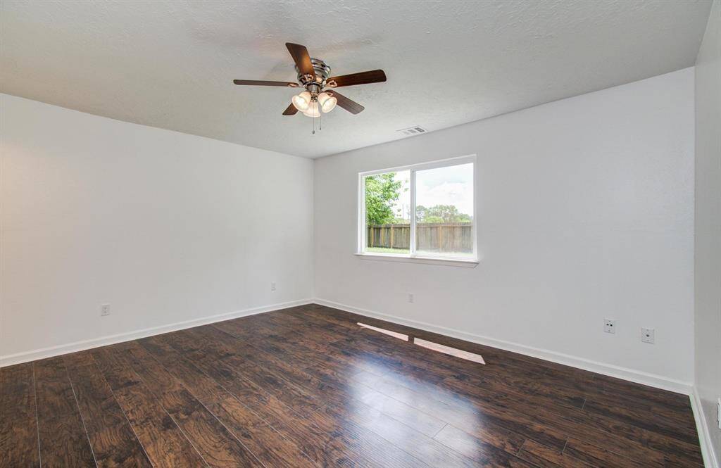 Primary bedroom with laminate flooring