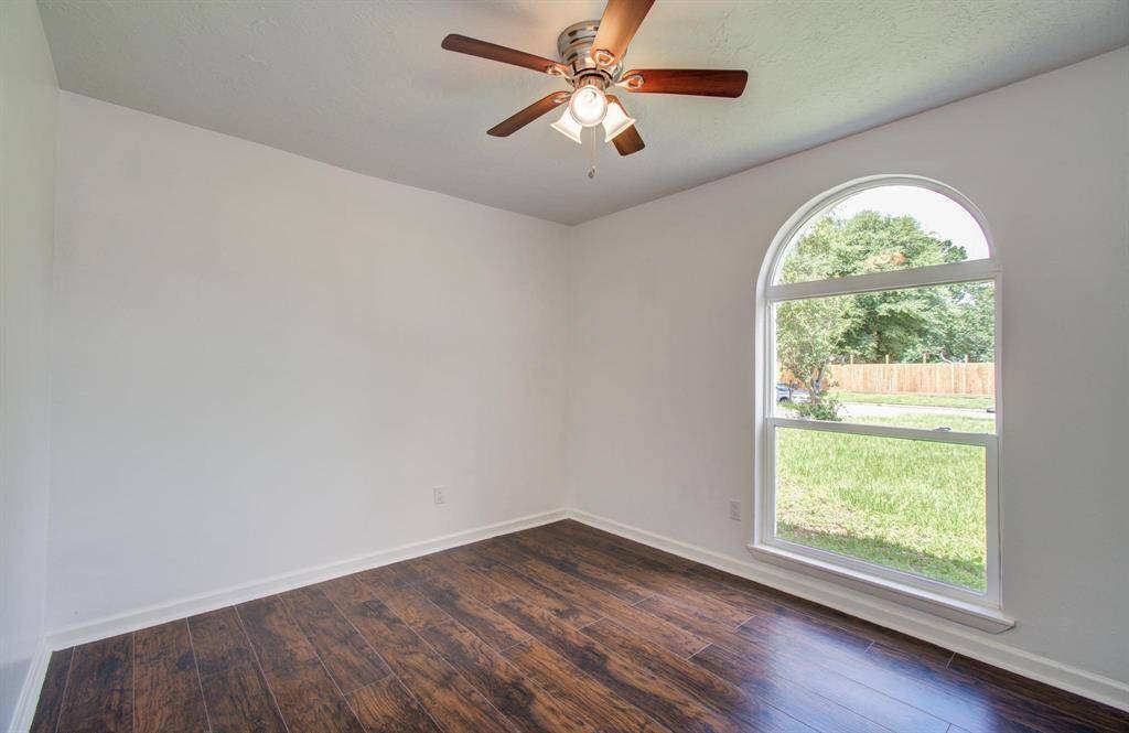 Second bedroom with a lovely half moon window, provides an excellent view of the front yard