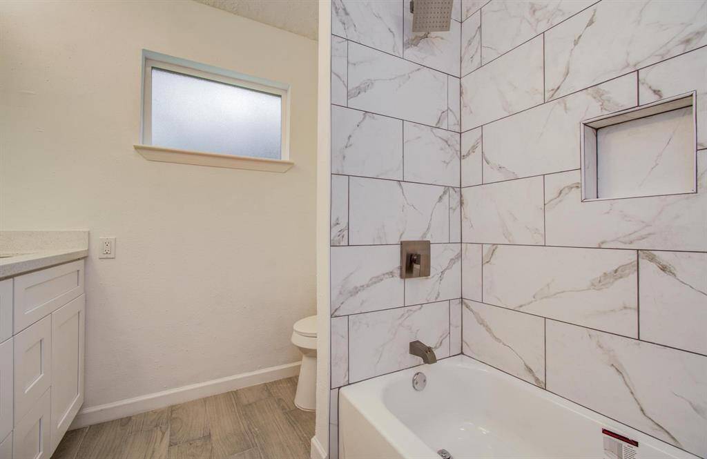 Second bathroom features a tub shower combo