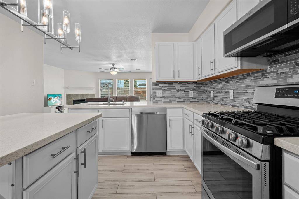 Check out the backsplash detail. The kitchen offers plenty cabinets