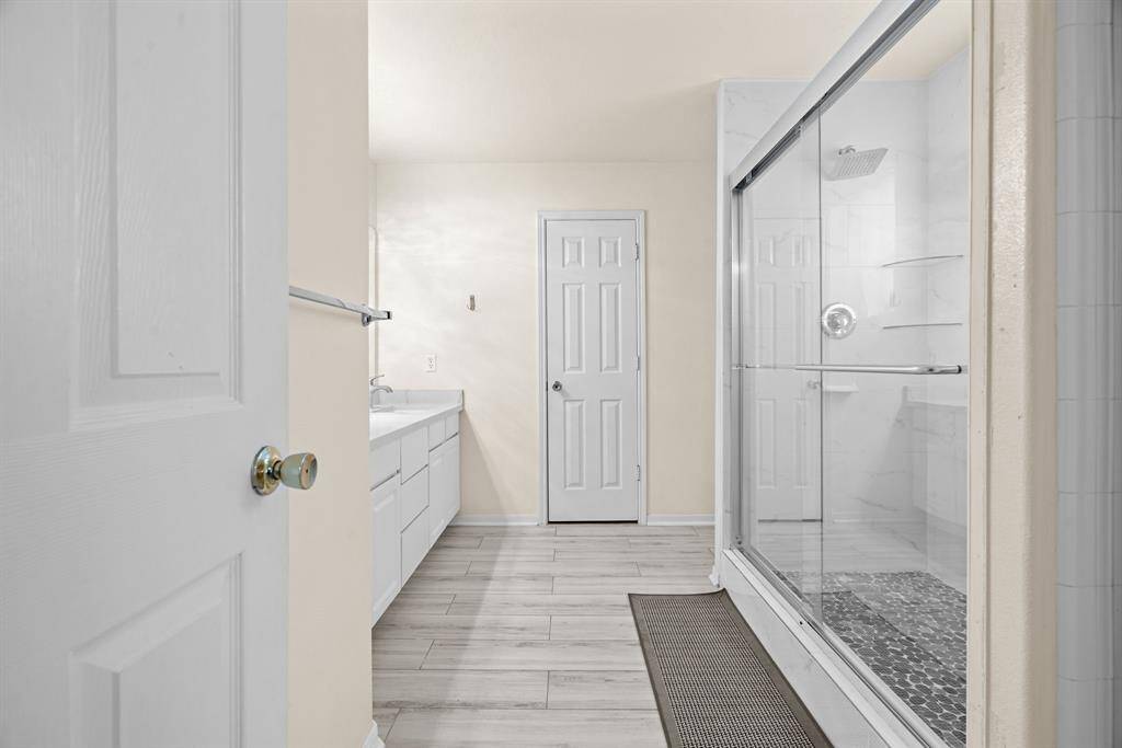 primary bedroom leads into the primary bathroom