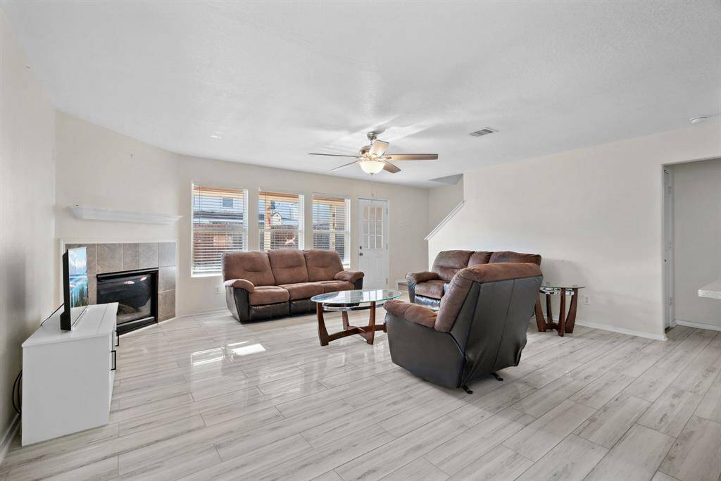 living room is spacious and has tile throughout the home