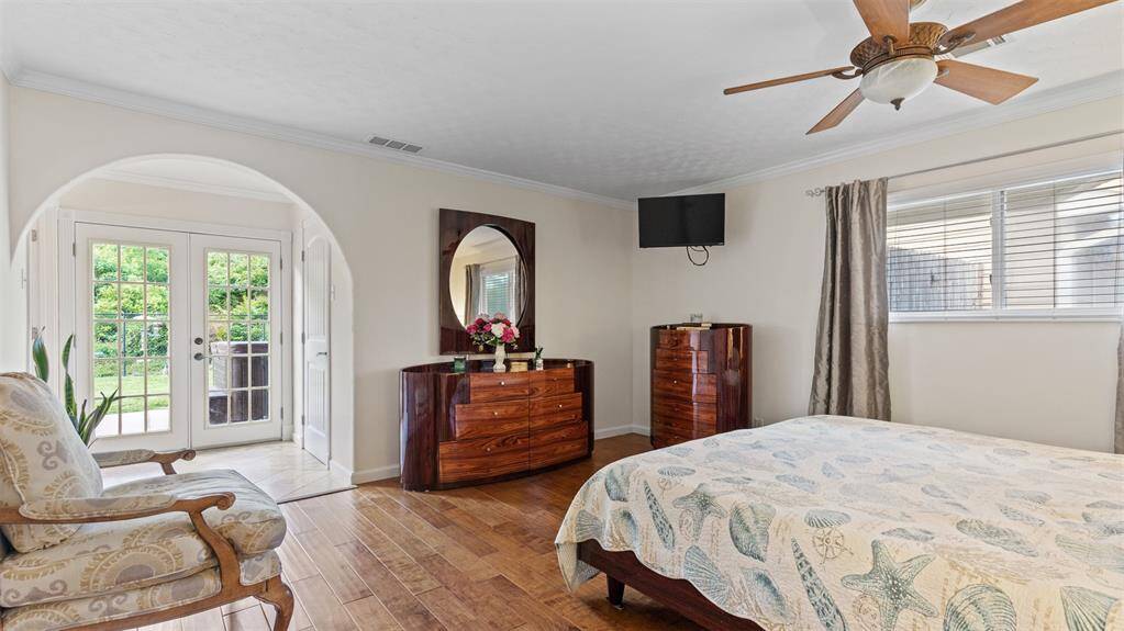 Primary Bedroom with patio access with views of hot tub and lush green space!