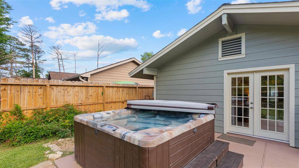 Relaxing hot tub on extended patio right outside your primary bedroom!