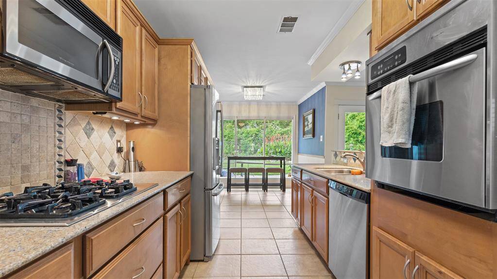 Granite countertops in the kitchen and bar area.