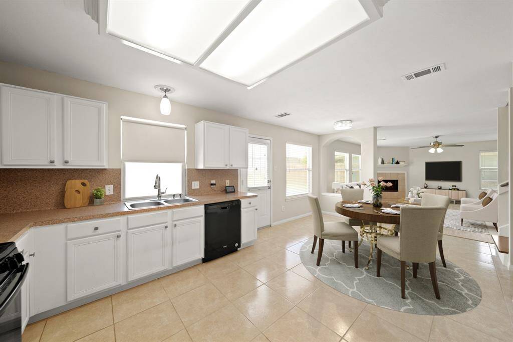 Stunning family room with laminate floors, a ceiling fan, and a gorgeous fireplace.