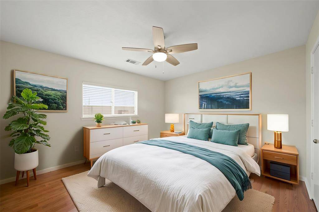 Virtually Staged: Secondary bedroom with laminate floors, a ceiling fan, neutral paint and windows with privacy blinds.