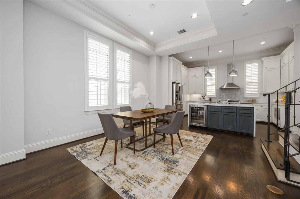 Gorgeous baseboards, a tray ceiling, and crisp white plantation shutters perfectly frame the dining space.
