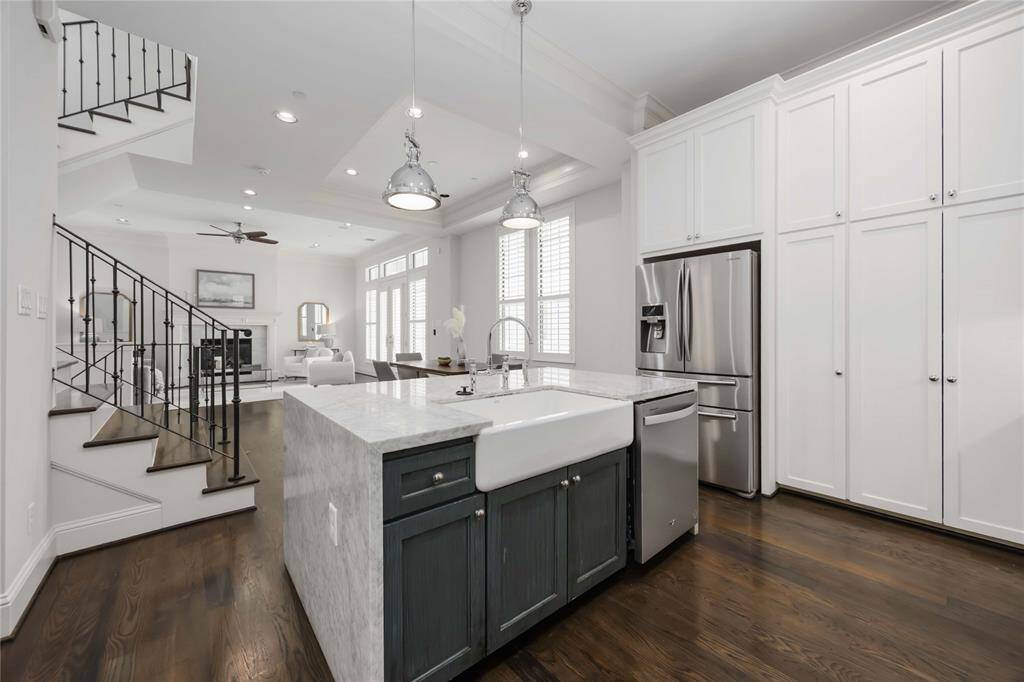 Storage is everywhere, from the multitude of cabinets to the extra storage located in the island. Notice that sleek apron-front sink!