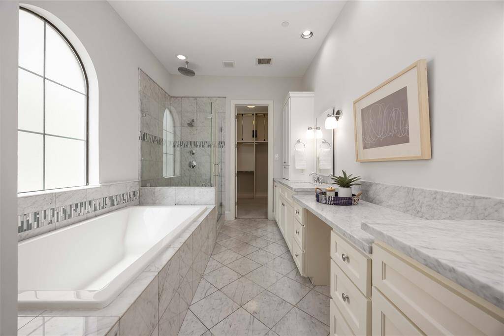 The room is the epitome of luxurious living. Enjoy a spa-like bathroom with a lovely soaking tub and a separate frameless shower.