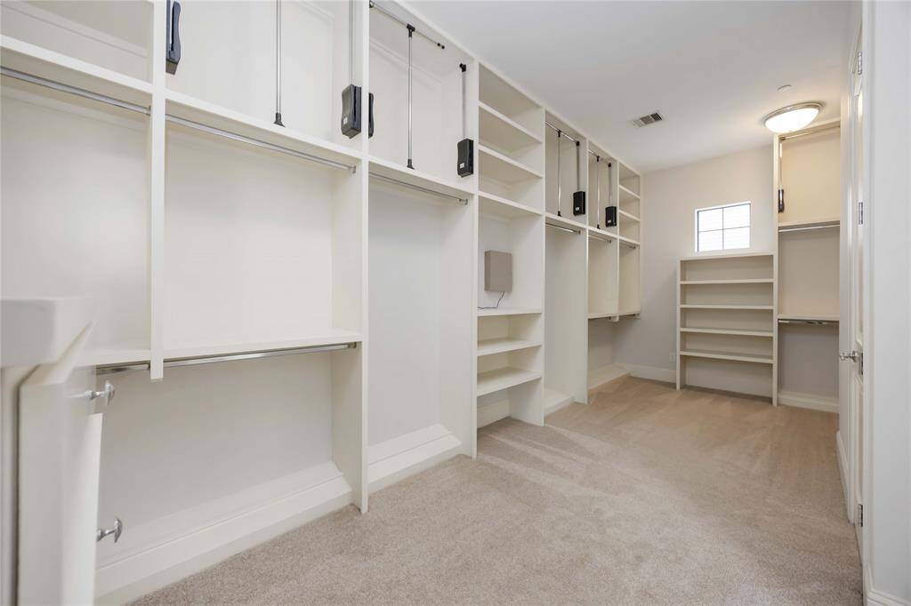Can you believe this closet? You could land a plane here! With so many location options for folded clothes, hanging clothes, shoes, and bags, you might need to buy more clothes!