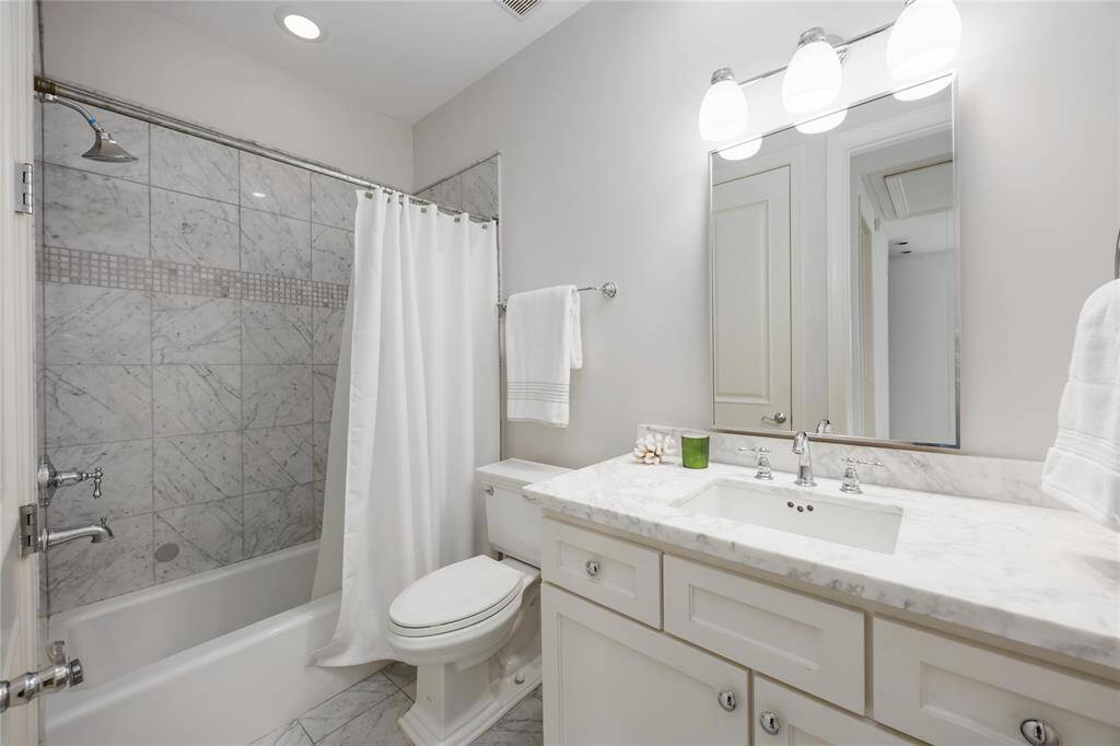 The bath on the 4th floor features a tub and shower combination.