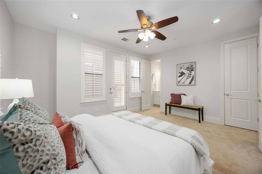 The spacious 1st-floor suite features high ceilings, recessed lighting, a private bath, and access to the side yard.