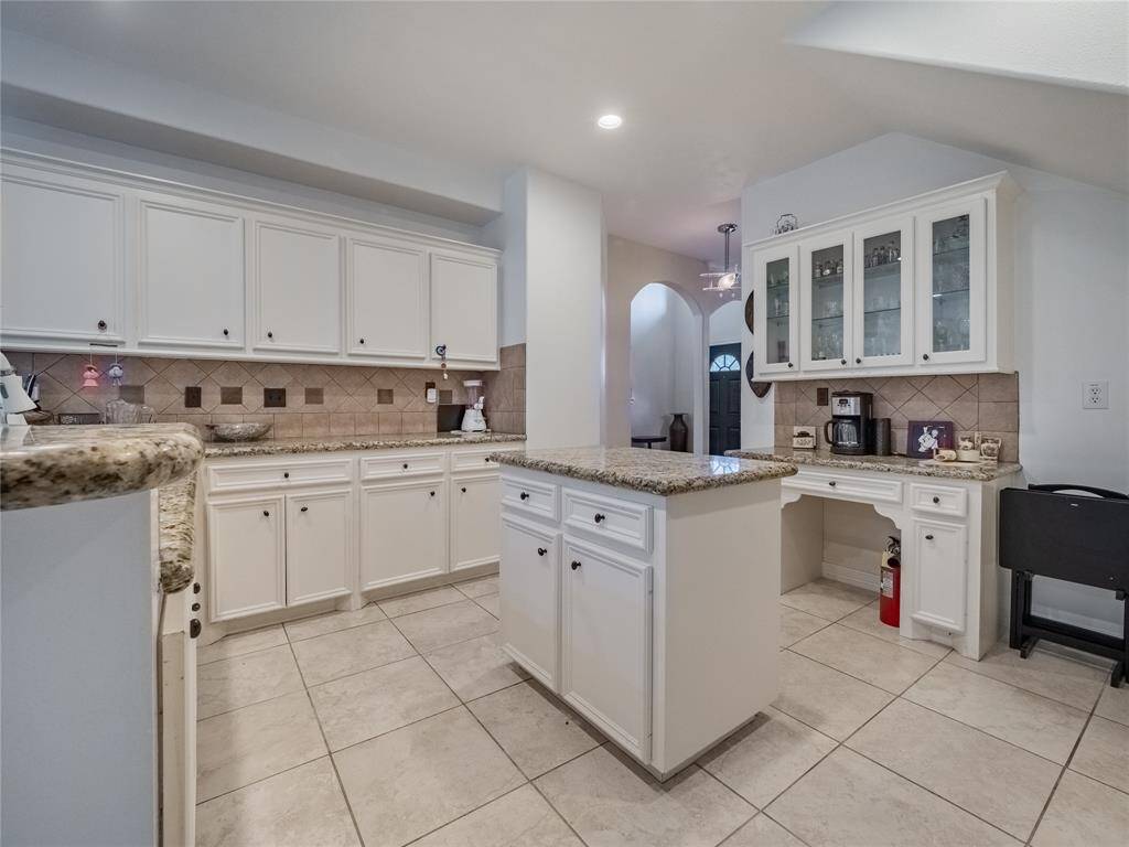 Kitchen boasts granite counter tops and ample cabinet space.