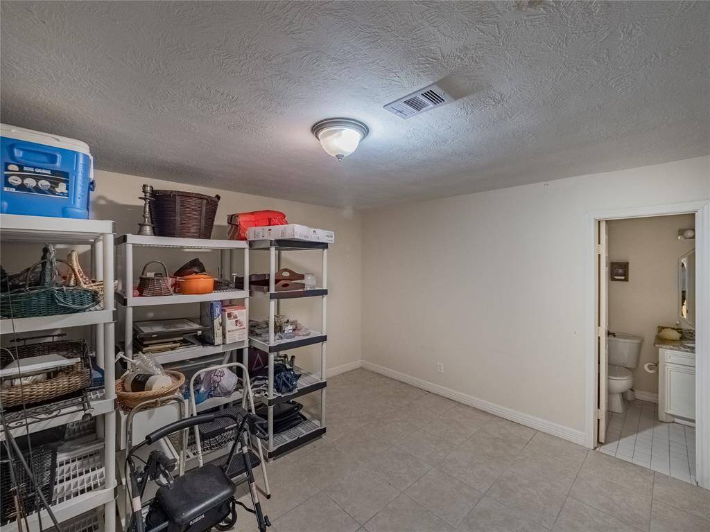 Fifth bedroom in the hanger with full bathroom and access to the backyard.  Would make a great guest suite.