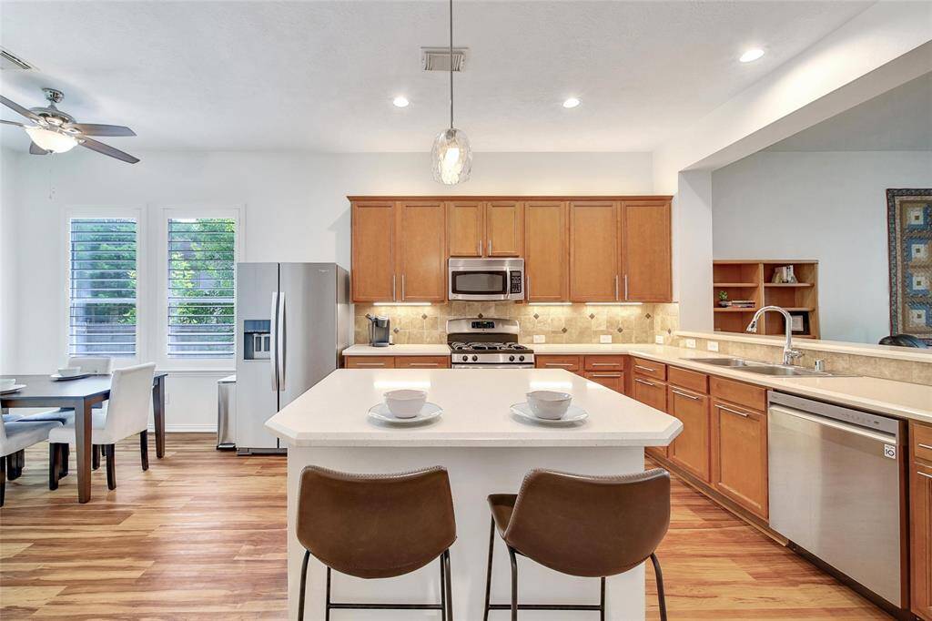Recessed lighting and pendant lights brighten the space.
