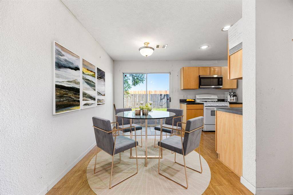 Sunny breakfast nook with room for a small table set, featuring cheerful natural light from the window and easy-care flooring an inviting spot for morning coffee or casual meals. *Virtually Staged