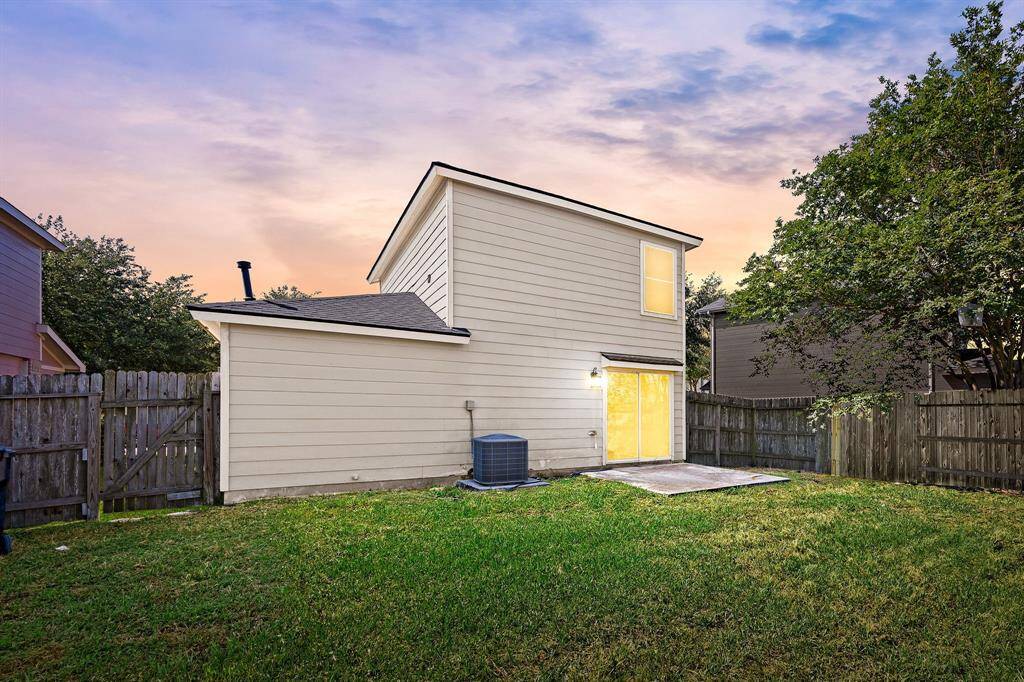 Private, easy-care backyard with a green lawn and room to garden or grill, an inviting outdoor retreat for pets, play, or simply unwinding under the open sky.