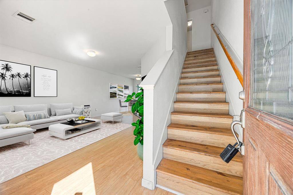 Step inside to a warm foyer where wood-look floors guides you toward the open living room, while the staircase rises to the second floor. Neutral paint, and high ceilings amplify the light, and a convenient under-stairs closet keeps the entry neat and welcoming. *Virtually Staged