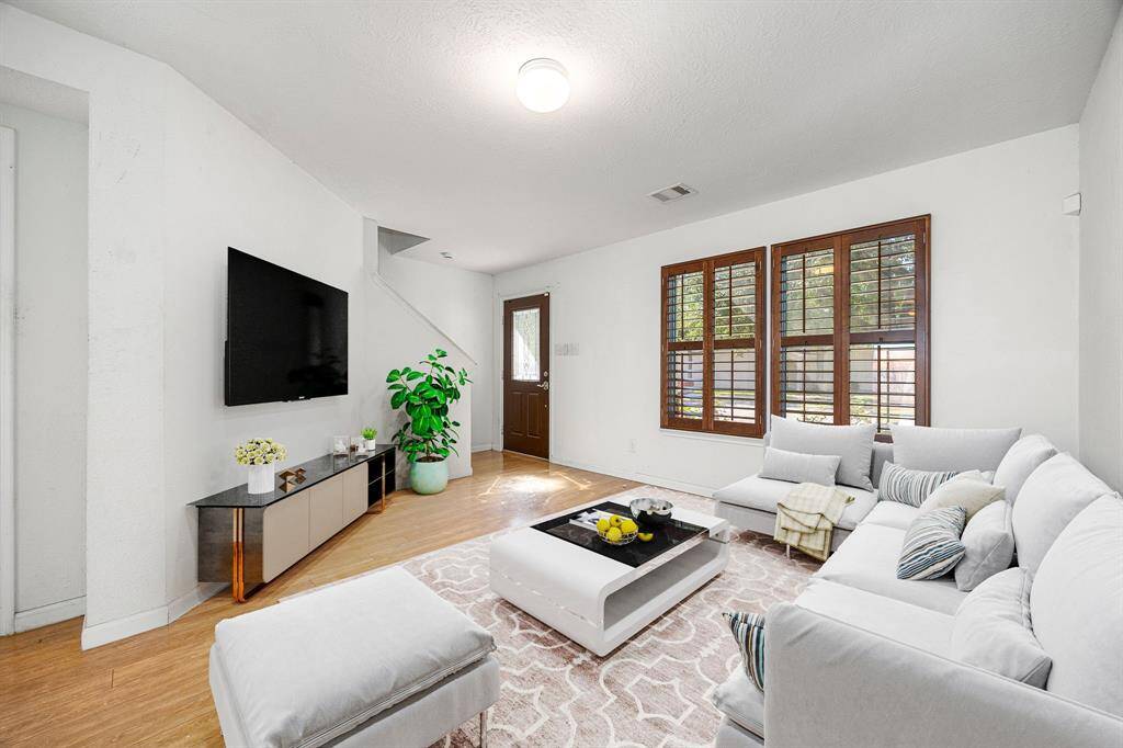 Gather the family and guests together in your lovely living room! Featuring high ceilings, custom paint, wood style floors and large windows that provide plenty of natural lighting throughout the day. *Virtually Staged