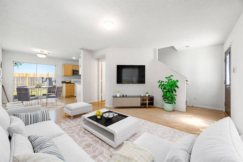 Gather the family and guests together in your lovely living room! Featuring fresh custom paint, wood style floors and large windows that provide plenty of natural lighting throughout the day. *Virtually Staged