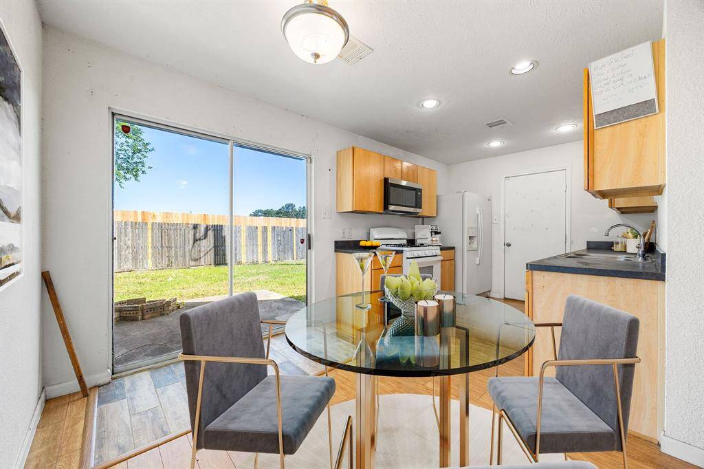 Start your day off right with a cup of coffee sitting with your family in the lovely breakfast area! Featuring a sliding door providing plemty of natural light, custom neutral paint, wood style flooring, recessed lighting and high ceilings. *Virtually Staged