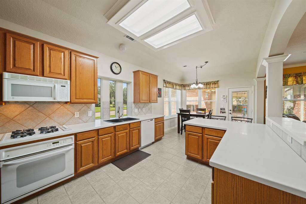 Open & beautifully lit kitchen offering bar seating and breakfast area.