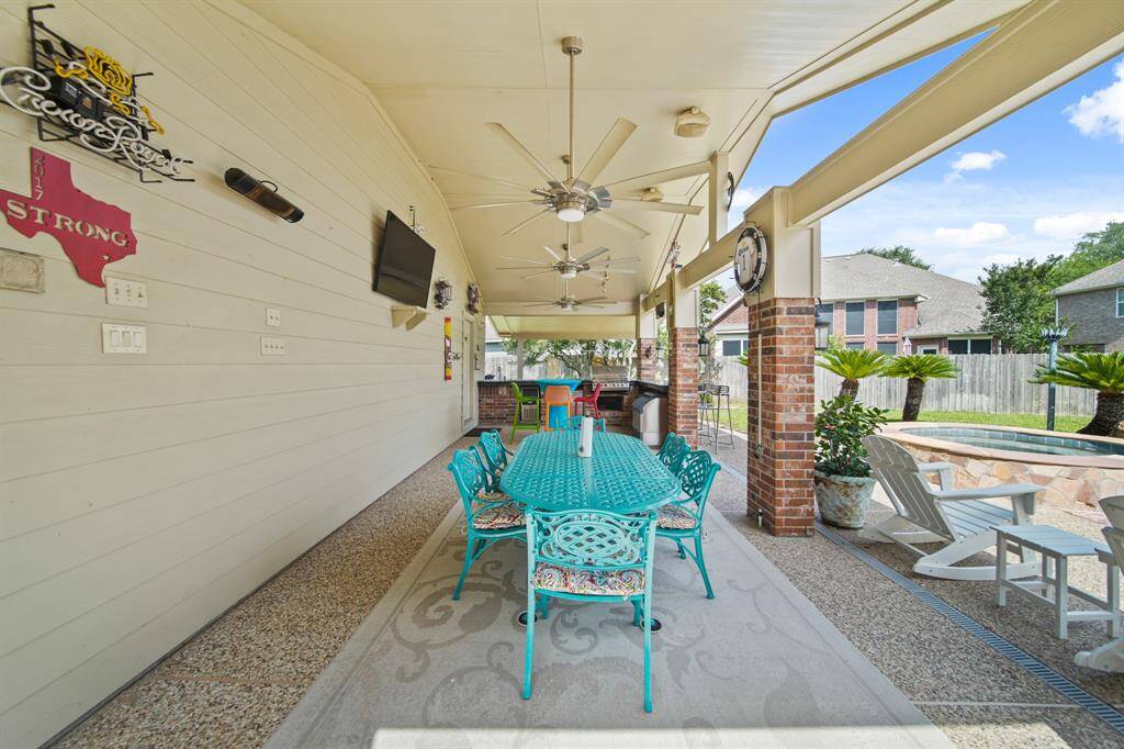 Impressive covered patio with outdoor kitchen including grill, 2 ice makers, & full outdoor bathroom.