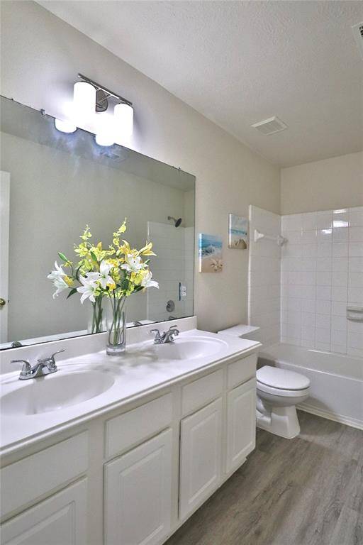 Secondary full  bathroom on 2nd floor features a clean, modern design with white cabinetry and a double vanity.