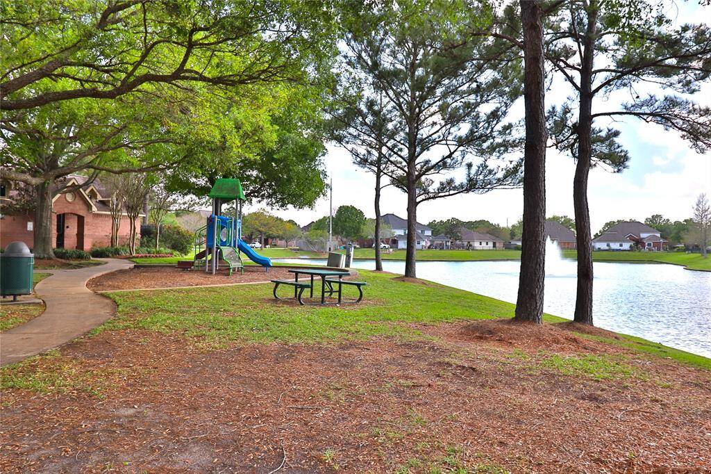 Serene community park featuring a playground, picnic area, and scenic pond, perfect for family outings and relaxation.