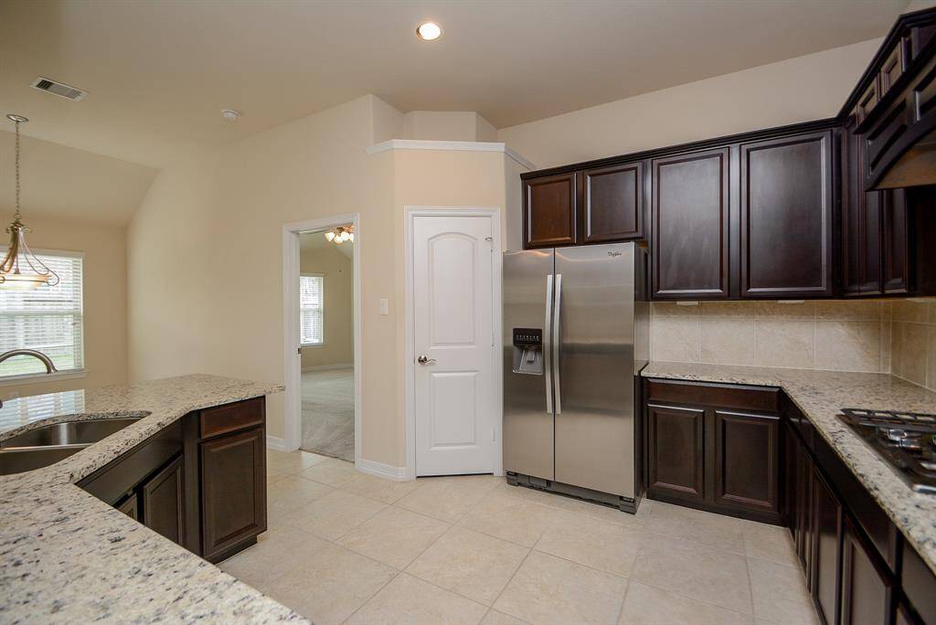 What a great open space for cook and helpers! The closet, center, opens into the generous pantry. The doorway, left, opens into the primary ensuite bed/bath.