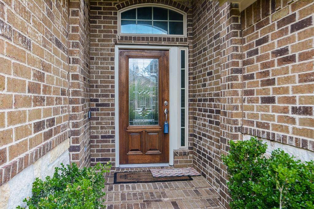 Elegant, but simple sets the theme for this home! The covered, recessed, brick enclosed front entrance adds privacy, shelter from the elements and is roomy enough for home deliveries.