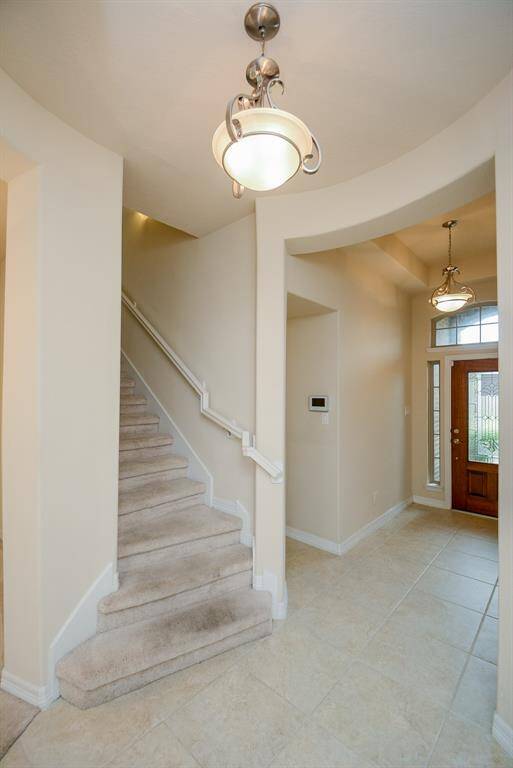 Here's a cozy inside view, picturing the proximity of the staircase and hallways from the elegant front entrance.