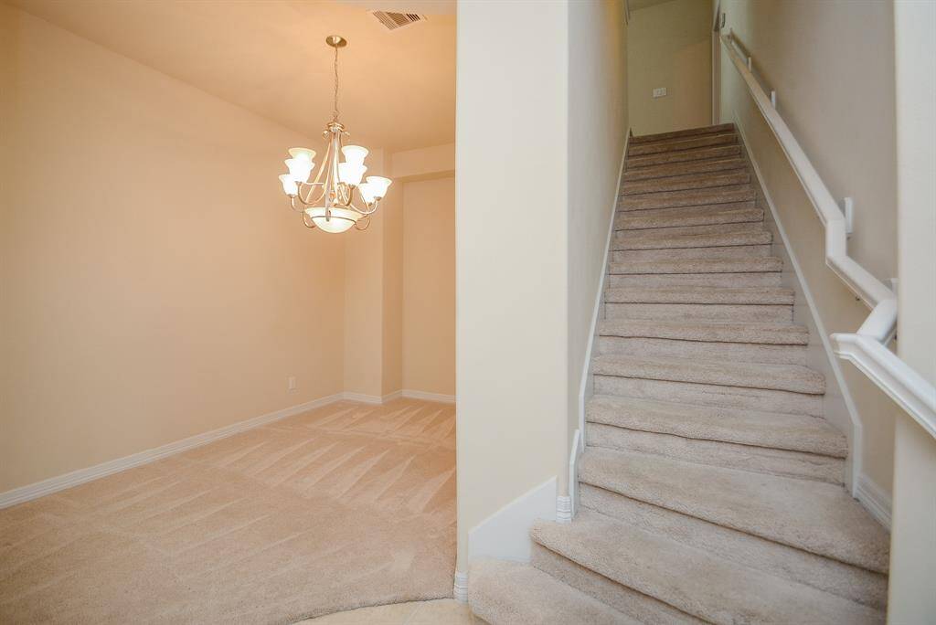 Modestlytucked away is the carpeted staircase to the large 2nd level. This view shows its convenient placement next to the space, left.