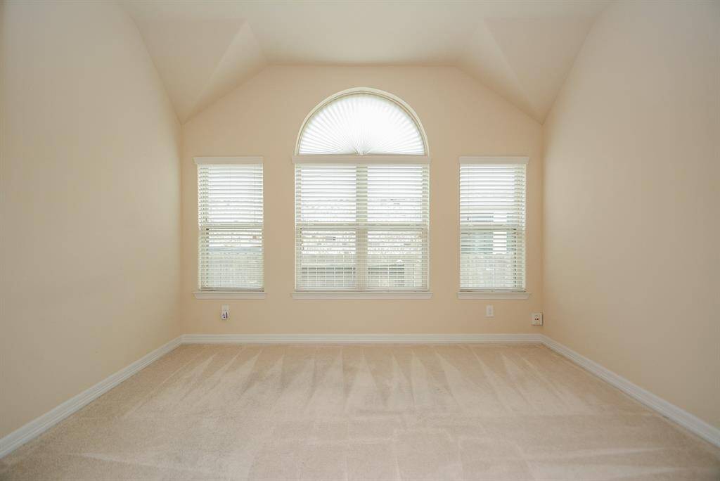 The perfect space for a home office, study, library or anything you wish! Note the high, detailed tray ceiling, arched window detail and simply relaxing color hues.