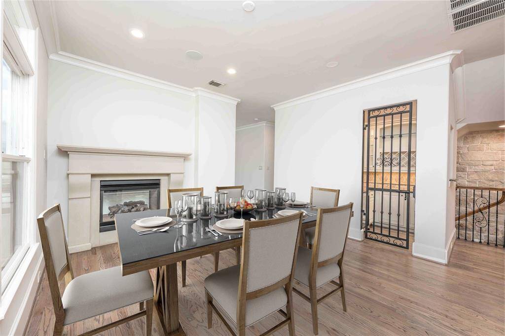 Elegant Dining Room Appointed With Dual Sided Fireplace & Wrought Iron Wine Grotto Details
