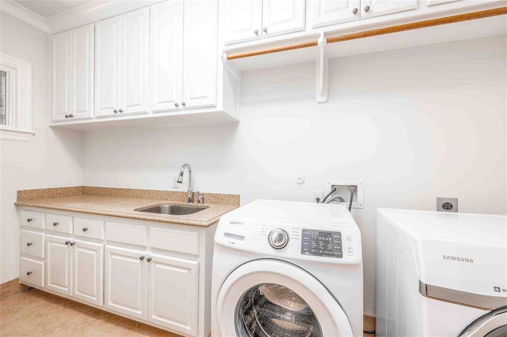 Adjacent To The Primary Is A Generous Sized Laundry Room With Extra Storage & Sink - Washer/Dry Convey With The Property