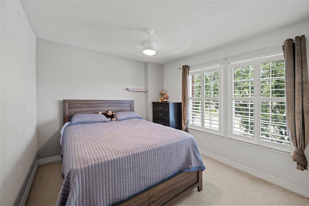 Upstairs secondary bedroom with plantation shutters.