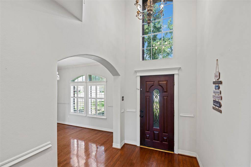 As you enter the home you are greeted by the high ceilings and wood flooring.